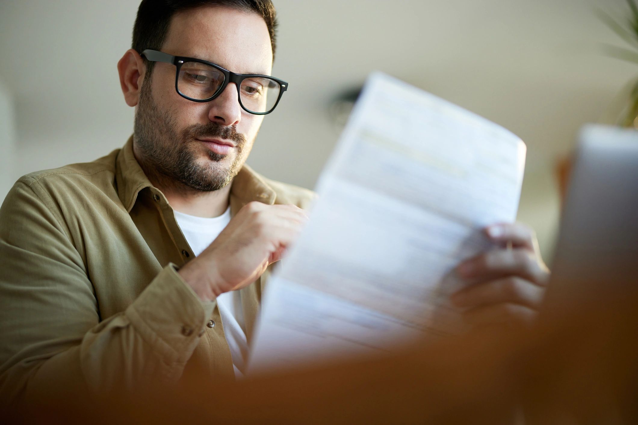 Entrepreneur reviewing invoices at a desk