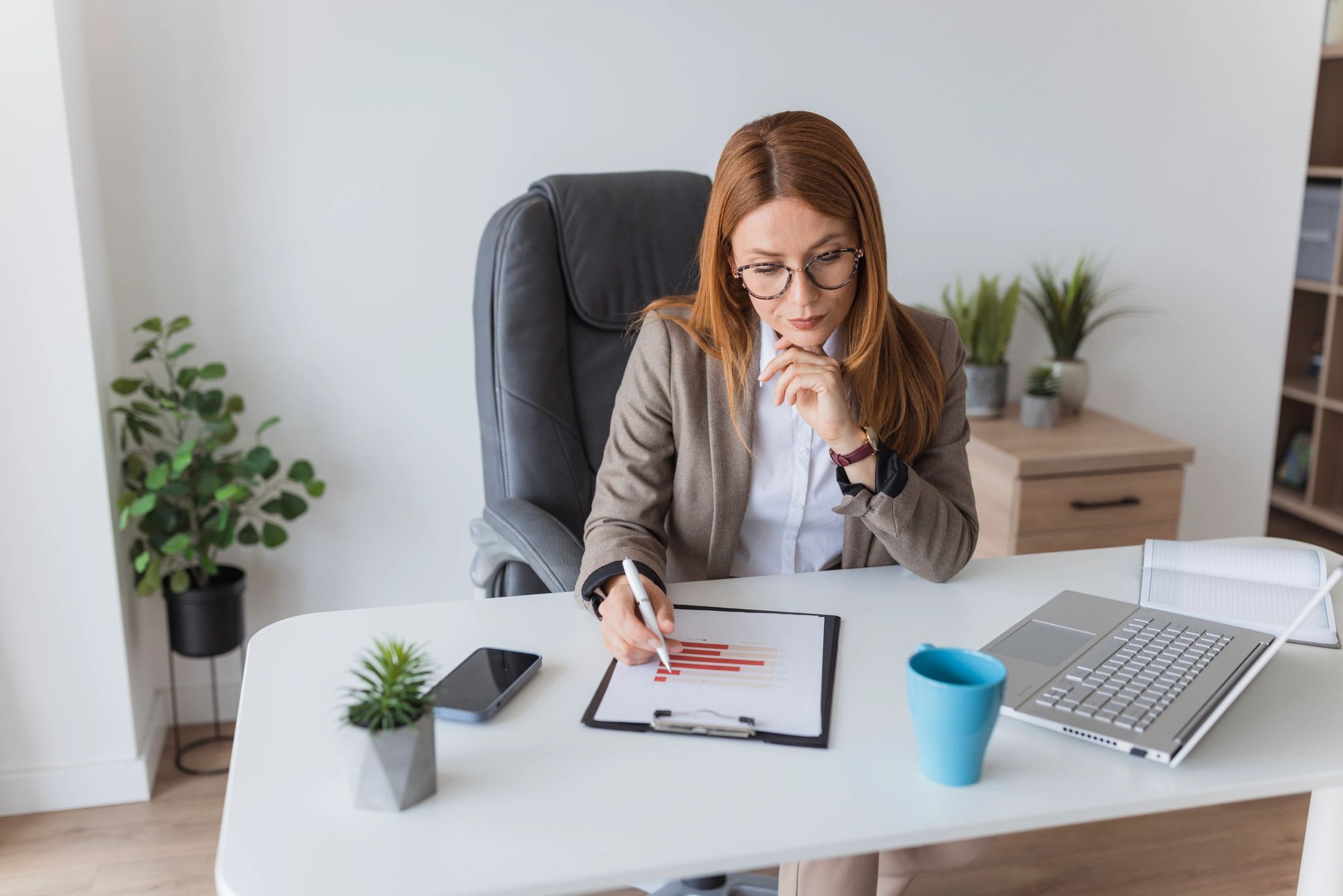 Bookkeeper reviewing financial reports at a desk